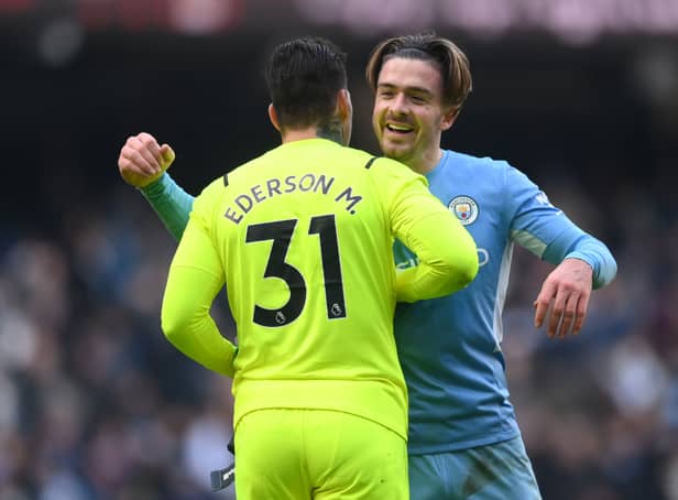<p> Jack Grealish embraces Ederson as Man City go 11 points clear Credit: Getty</p>