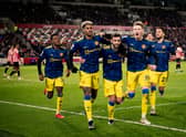 Manchester United celebrate scoring against Brentford. Credit: Getty.