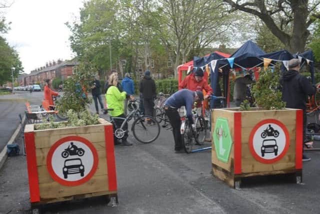 A cycle repair event being held at the LTN filters on Manor Road in Levenshulme