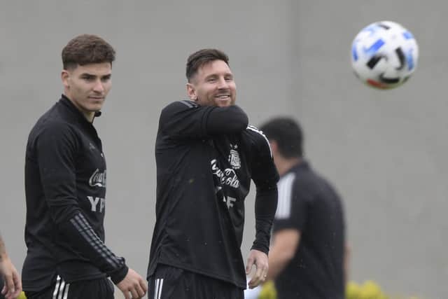 Argentina’s forward Lionel Messi gestures next to forward Julian Alvarez during a training session in Ezeiza, Buenos Aires province, on October 13, 2021, on the eve of a FIFA World Cup Qatar 2022 qualifier against Peru