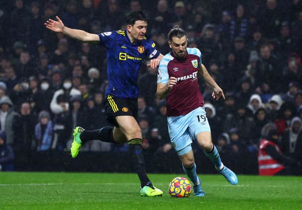 Jay Rodriguez of Burnley moves forward past Harry Maguire of Manchester United. (Photo by Clive Brunskill/Getty Images)