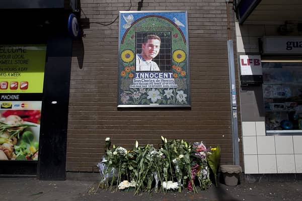 Flowers are left by a mosaic dedicated to Brazilian Jean Charles de Menezes outside Stockwell Underground Station on the tenth anniversary of his death in London on July 22 2015.