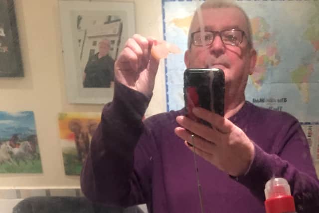 Paul Bishop, 63, said he thought it was a joke when an envelope carrying his missing teeth, covered in Spanish postmarks, turned up on his door yesterday Credit: SWNS