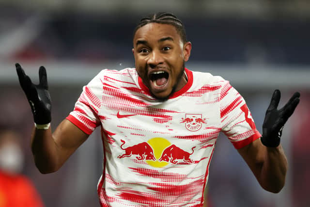 Christopher Nkunku of RB Leipzig celebrates after scoring their sides first goal during the Bundesliga match between RB Leipzig and 1. FC Koln at Red Bull Arena on February 11, 2022 in Leipzig, Germany