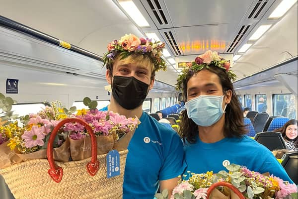 Flowers being given out on a Northern train
