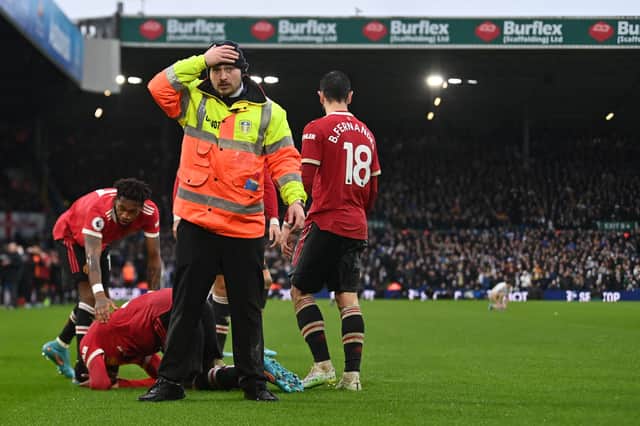Anthony Elanga went down after being hit by an object throw from the Leeds fans. Credit: Getty.