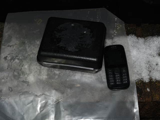 A phone and a firearm recovered by police
