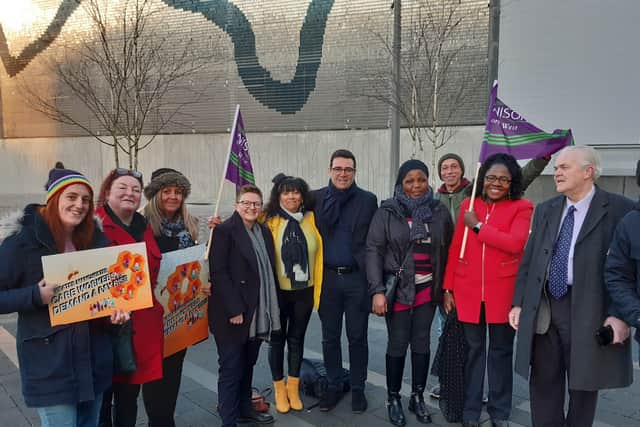 Social care workers lobbying Coun Bev Craig and mayor Andy Burnham at a GMCA meeting