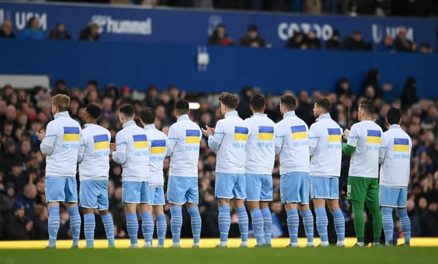 Manchester City players adorn t-shirts saying ‘no to war’. Credit: Getty