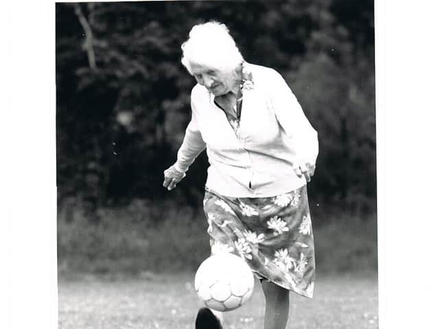 <p>Alice Woods, who played for the Dick, Kerr Ladies, proving she had not lost her ball skills in her 80s</p>