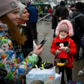 A young refugee girl from Ukraine waits to enter a bus at the Moldova-Ukrainian border’s checkpoint Credit: Getty