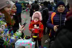 A young refugee girl from Ukraine waits to enter a bus at the Moldova-Ukrainian border’s checkpoint Credit: Getty