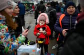 A young refugee girl from Ukraine waits to enter a bus at the Moldova-Ukrainian border’s checkpoint Credit: Getty