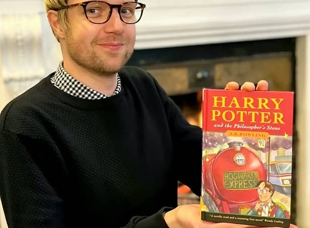 <p>Jim Spencer with the pristine first edition of Harry Potter and the Philosopher’s Stone sold by a Sussex man.   Credit: Hansons / SWNS</p>