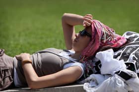 A woman enjoys a hot and sunny day in Piccadilly Gardens in Manchester. (Photo by Christopher Furlong/Getty Images)