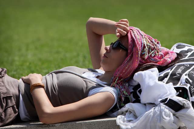 A woman enjoys a hot and sunny day in Piccadilly Gardens in Manchester. (Photo by Christopher Furlong/Getty Images)