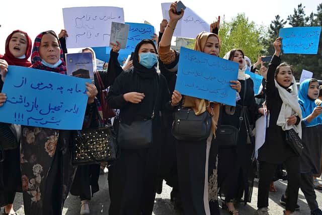 Afghan women and girls take part in a protest  demanding that high schools be reopened for girls. Photo: Ahmad Sahel Arman/AFP via Getty Images