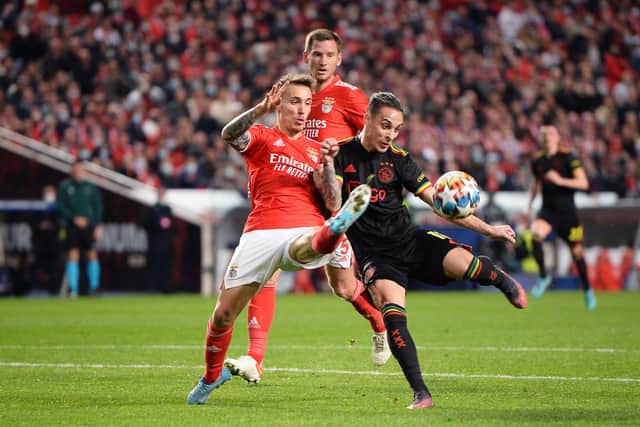 : Antony of Ajax shoots under pressure from Alex Grimaldo of Benfica during the UEFA Champions League Round Of Sixteen Leg One match between SL Benfica and AFC Ajax at Estadio da Luz on February 23, 2022