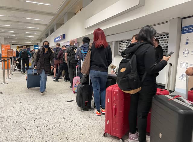 Passengers queue for check in at Manchester Airport Credit: Getty 