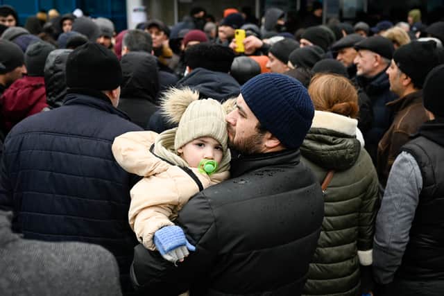 Families arrive at a refugee camp in Lodova, having fled Ukraine Credit: Getty
