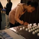 A woman lights candles during a community Passover Seder Credit: Getty