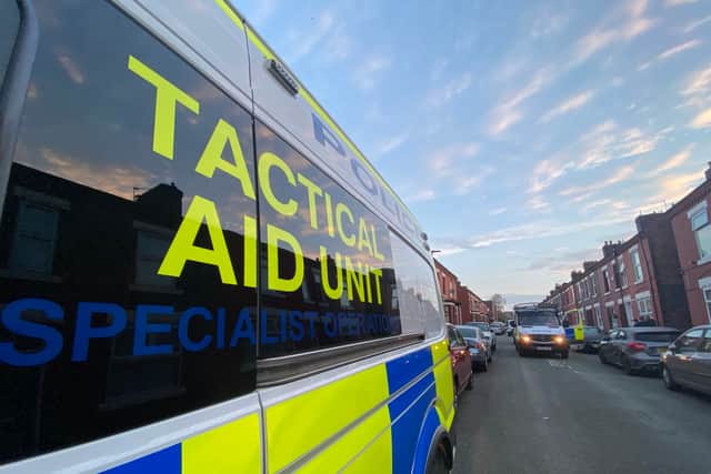 Police on a raid in response to the Cheetham Hill shooting incident Credit: Gmp