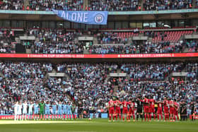Manchester City and Liverpool players observed a minute’s silence before the game. Credit: Getty.