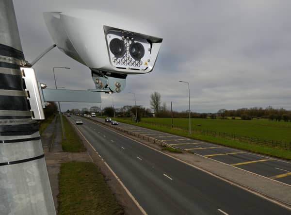 A Manchester Clean Air Zone automatic number plate recognition camera Credit: Getty 