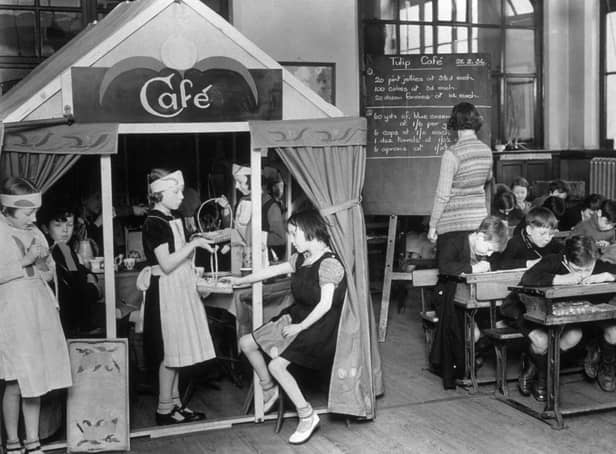 <p>Schoolchildren learn maths from a toy post office Credit: Getty </p>
