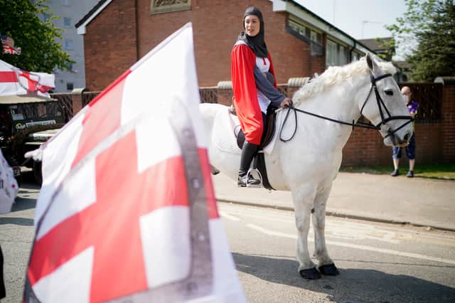 A girl dressed as Saint George rides her white horse as they lead the Manchester St George’s Day parade in 20189 Credit: Getty
