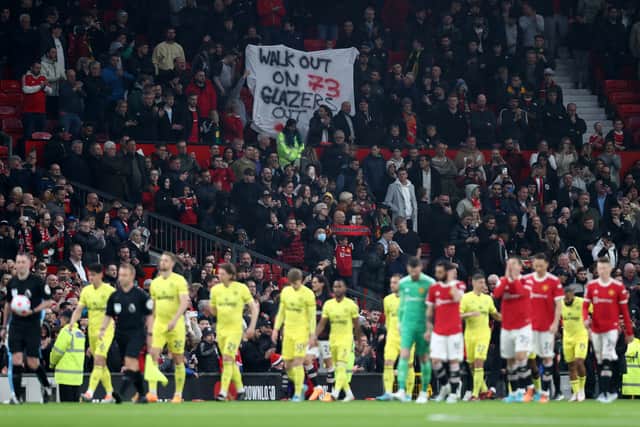 A banner calling for fans to walk out on 73 minutes was seen at Old Trafford in the win against Brentford. Credit: Getty.