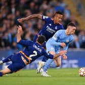 Phil Foden of Manchester City gets away from Daniel Carvajal and Eder Militao of Real Madrid during during the UEFA Champions League Semi Final Leg One match between Manchester City and Real Madrid at City of Manchester Stadium 