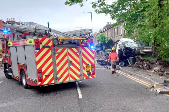 Fire crews deal with the aftermath in Blackburn Road, Egerton Credit: SWNS