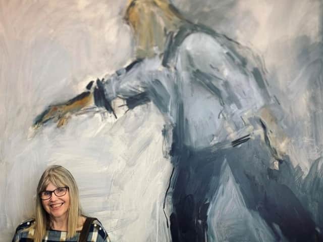 <p>Ghislaine Howard with one of her paintings</p>
