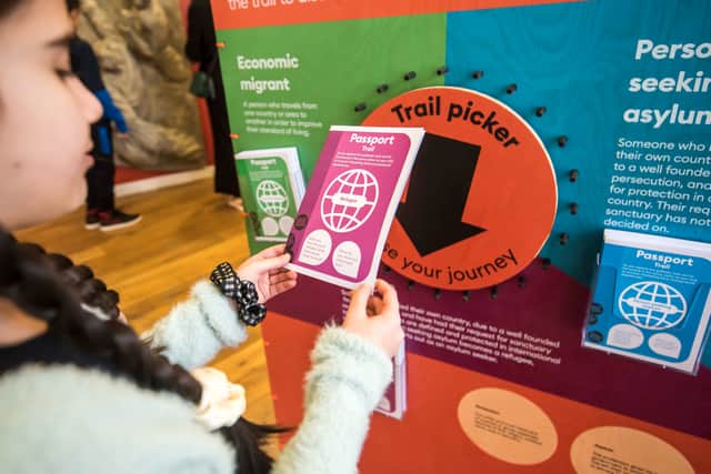 A visitor using the Passport Trail at the museum, part of its exploration of the subject of migration