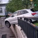 A dramatic photograph shows the silver Audi teetering on a kerb after police tried to pull the driver over on Sunday morning in Bury Credit: Greater Manchester Police / SWNS