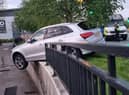 A dramatic photograph shows the silver Audi teetering on a kerb after police tried to pull the driver over on Sunday morning in Bury Credit: Greater Manchester Police / SWNS
