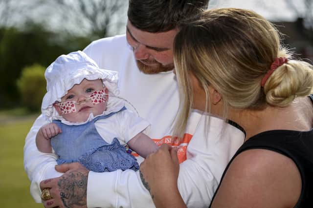 Elsie with her parents Katie and Rob Hampson Credit: SWNS