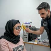 Optometrist Yousuf Mohammad performing an eye test