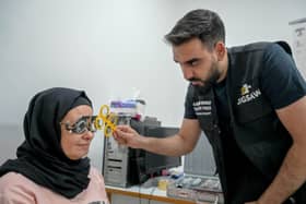 Optometrist Yousuf Mohammad performing an eye test