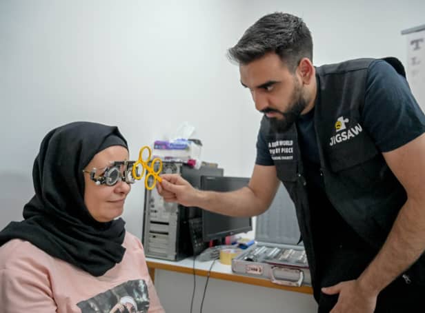 <p>Optometrist Yousuf Mohammad performing an eye test</p>
