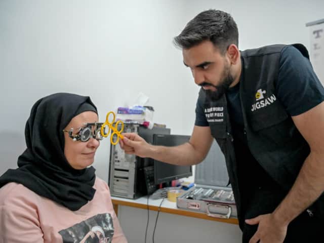 <p>Optometrist Yousuf Mohammad performing an eye test</p>