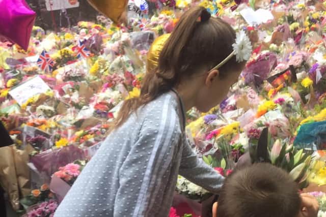 Lily and Jack laying flowers in Manchester after the Arena attack