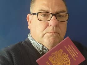 David Chadwick with his passport Credit: David Chadwick / SWNS