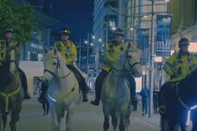 Police officers on horses in a shot from the documentary A Manchester Story