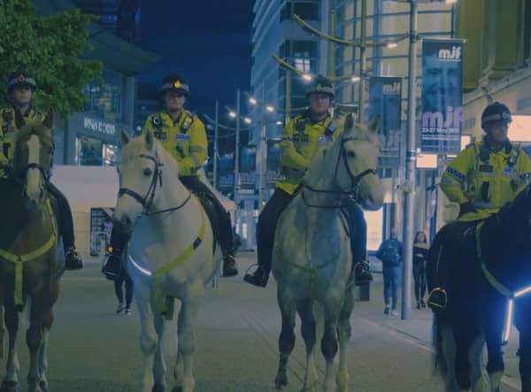 Police officers on horses in a shot from the documentary A Manchester Story