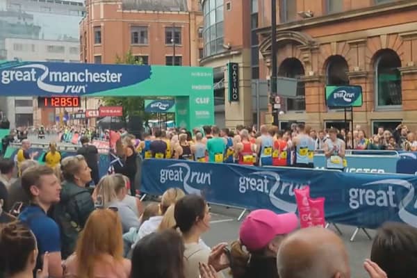 Runners and spectators join the applause in tribute to those who died in the Manchester Arena attack