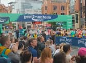 Runners and spectators join the applause in tribute to those who died in the Manchester Arena attack