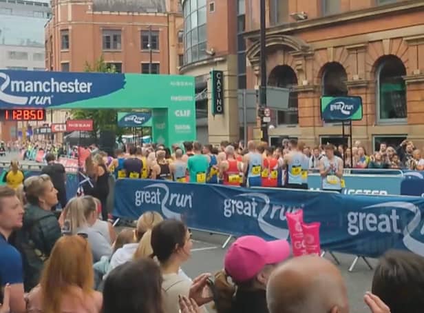 <p>Runners and spectators join the applause in tribute to those who died in the Manchester Arena attack</p>