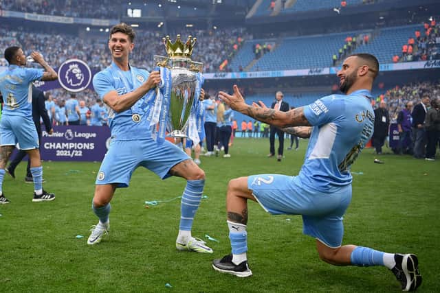 John Stones and Kyle Walker of Manchester City celebrate with the Premier League trophy Credit: Getty